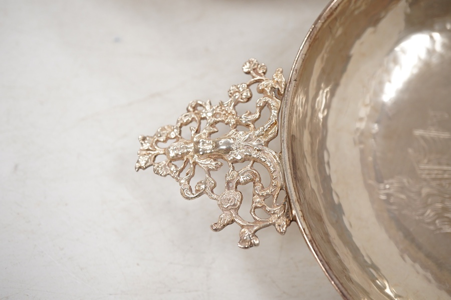 A pair of George V continental silver quaichs, with pierced lug handles and each engraved with a three-masted ship at sea, import marks for Berthold Hermann Muller, London, 1913, 17.3cm.